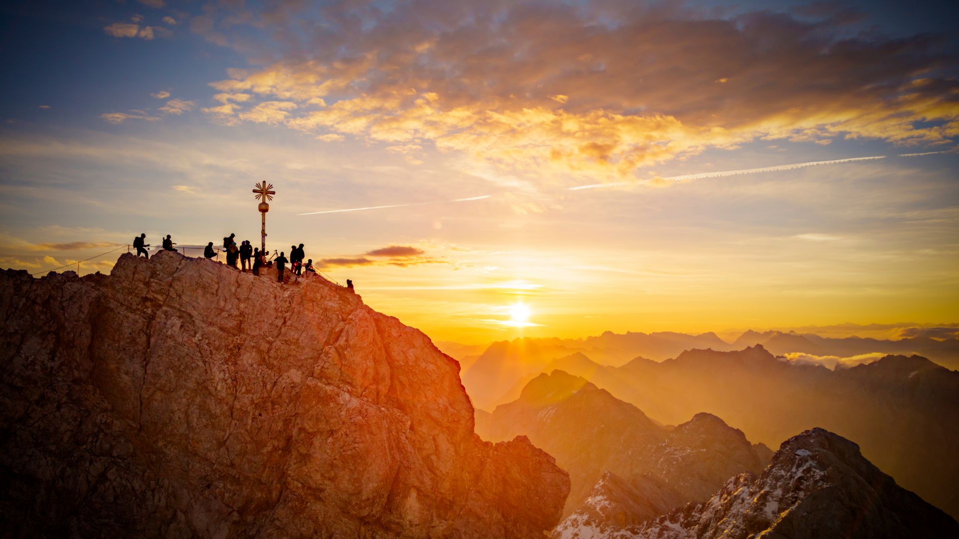 Zugspitze: summit of Mount Zugspitze, Germany's highest mountain in front of the rising sun.