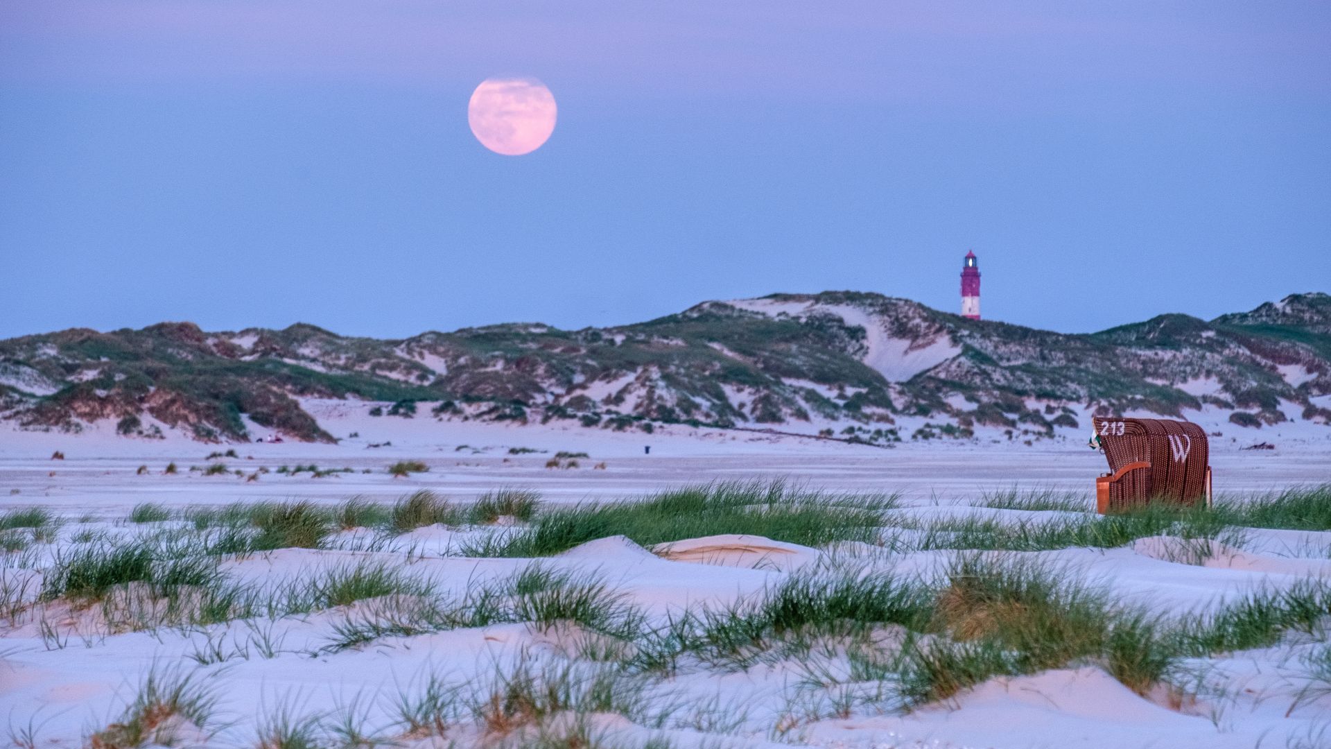 Amrum: full moon over the beach, light house, beach chair
