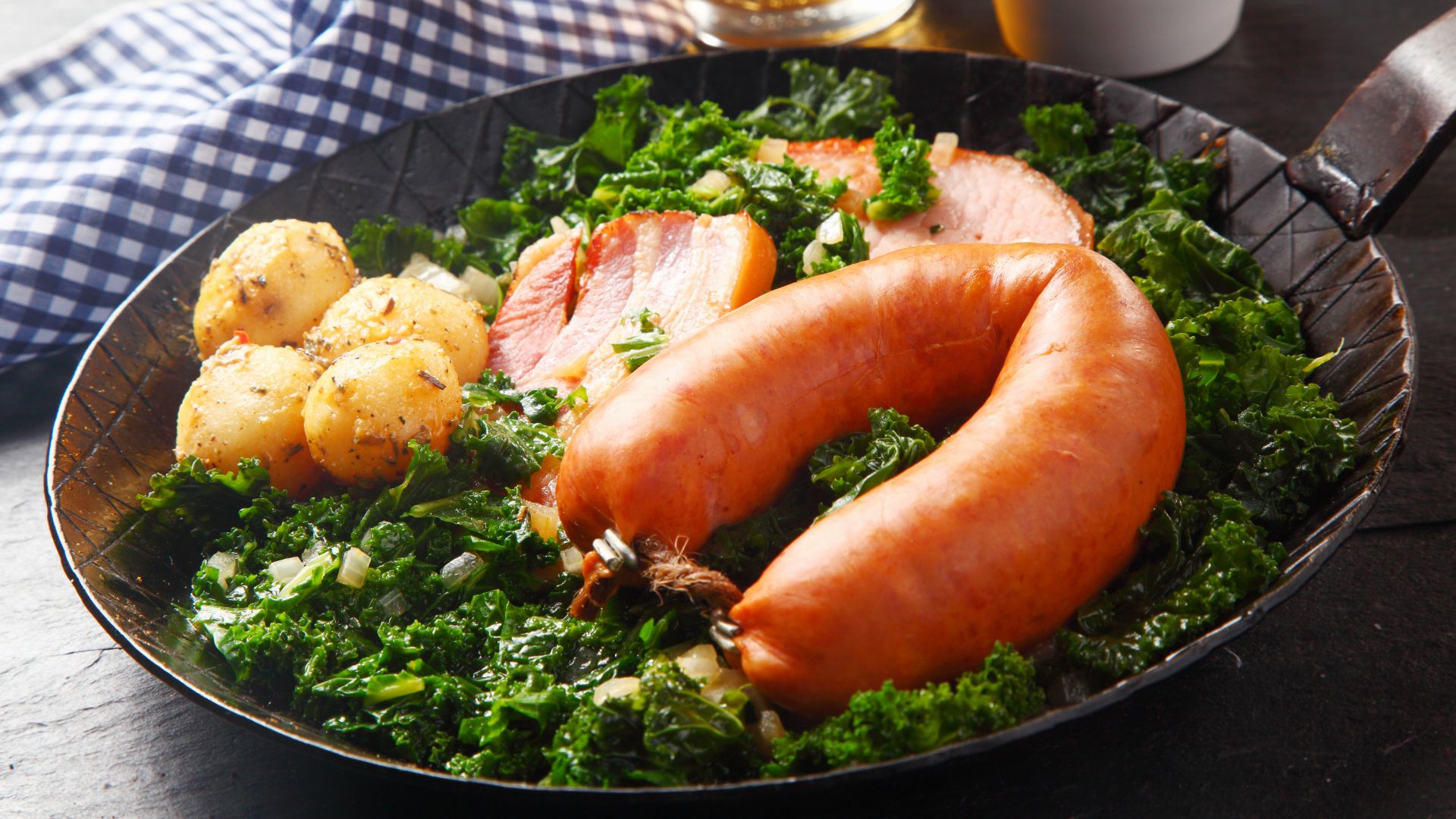 Kale dish in a pan with potatoes and sausage