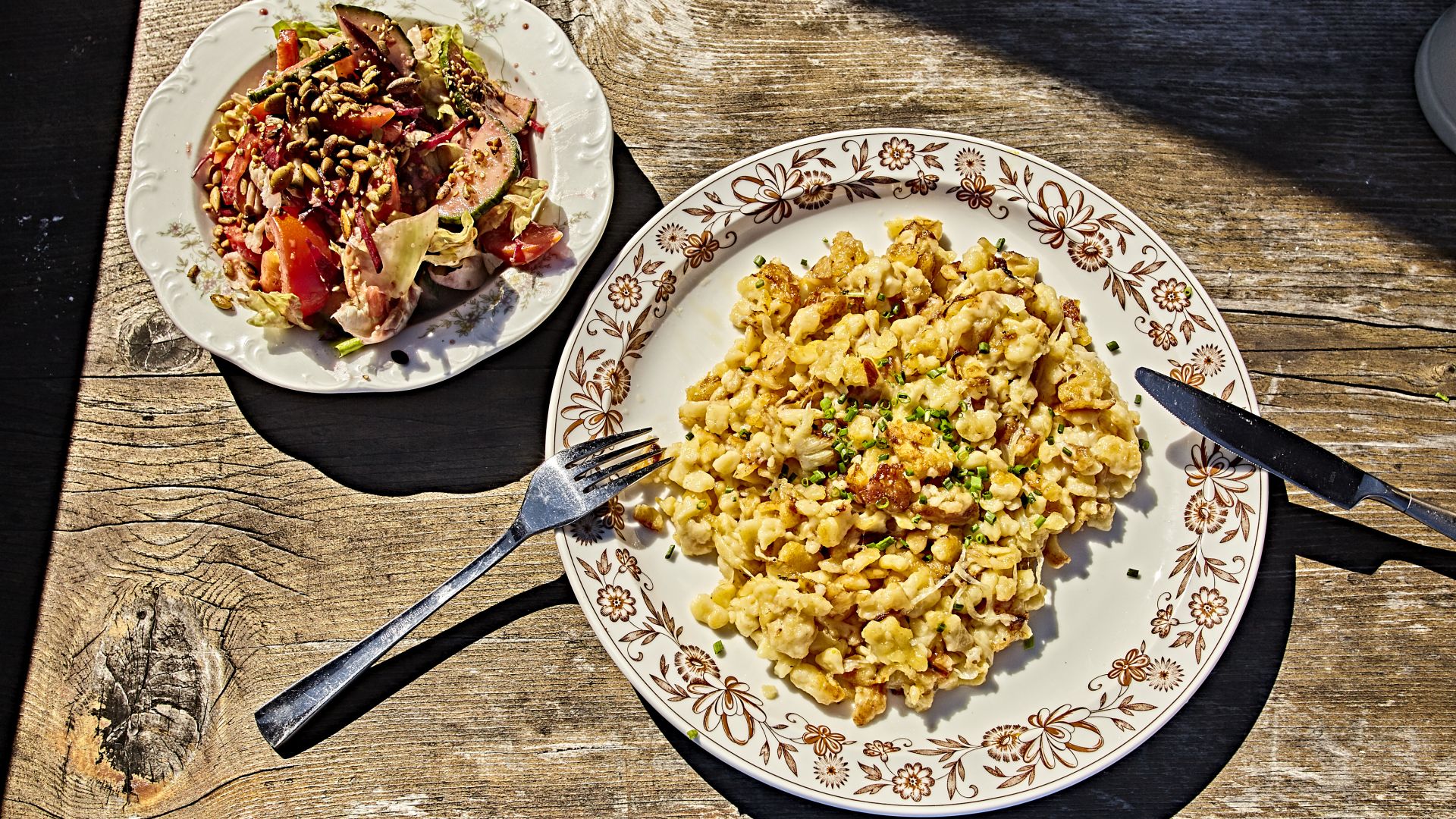 Vegan cheese spaetzle and salad served on plates