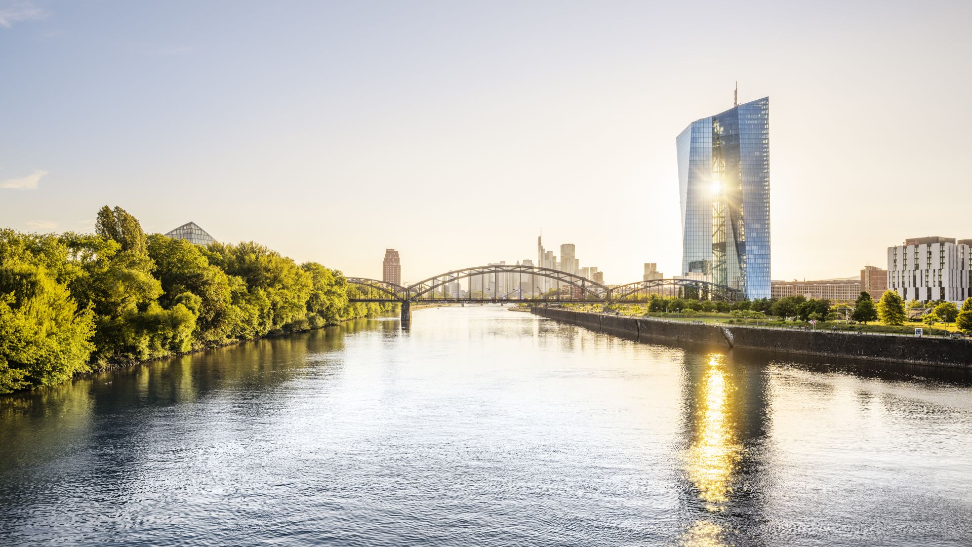 The Frankfurt skyline and the ECB reflected in the waters of the Main at sunset